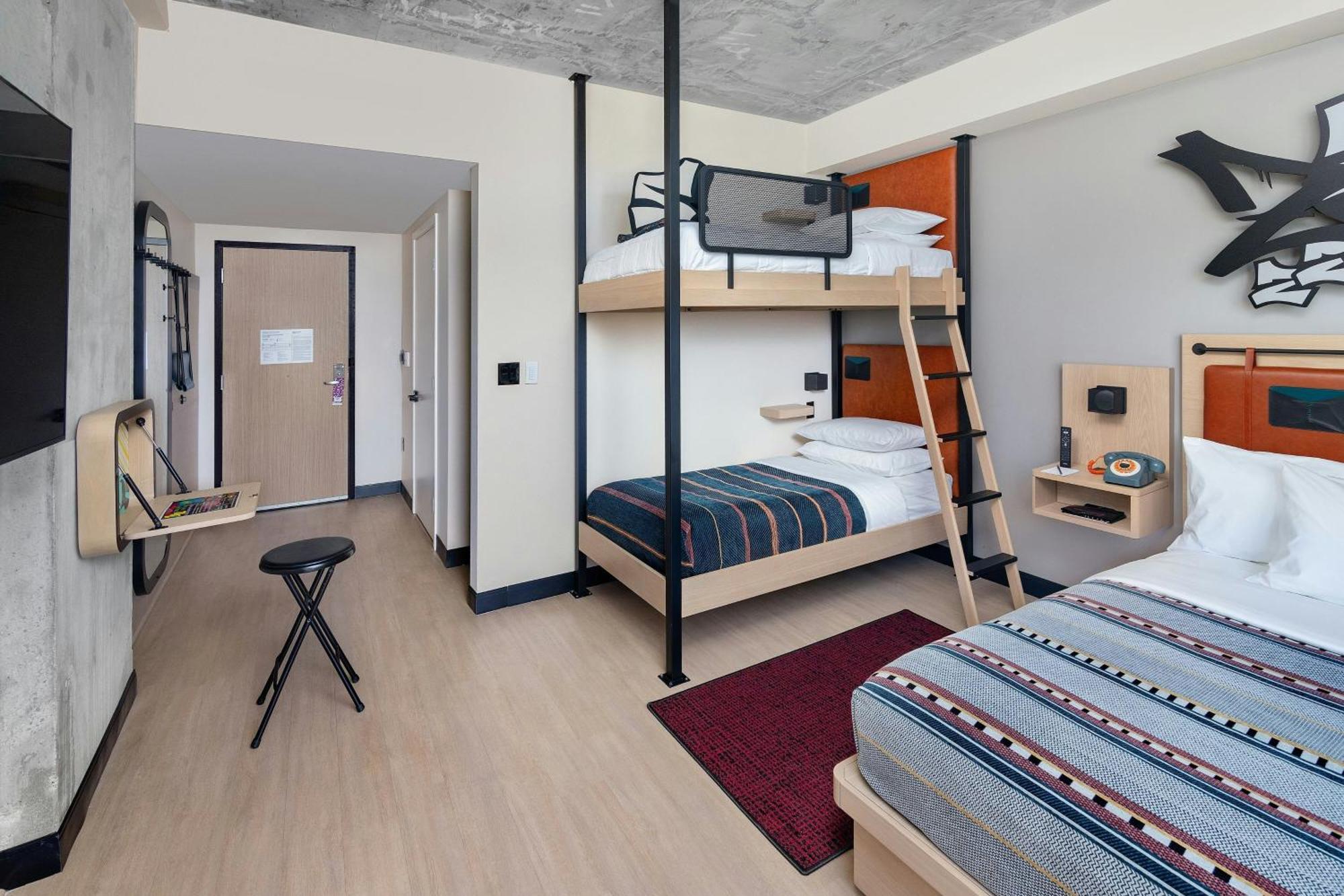 Room with One Queen Bed and One Set of Bunk Beds